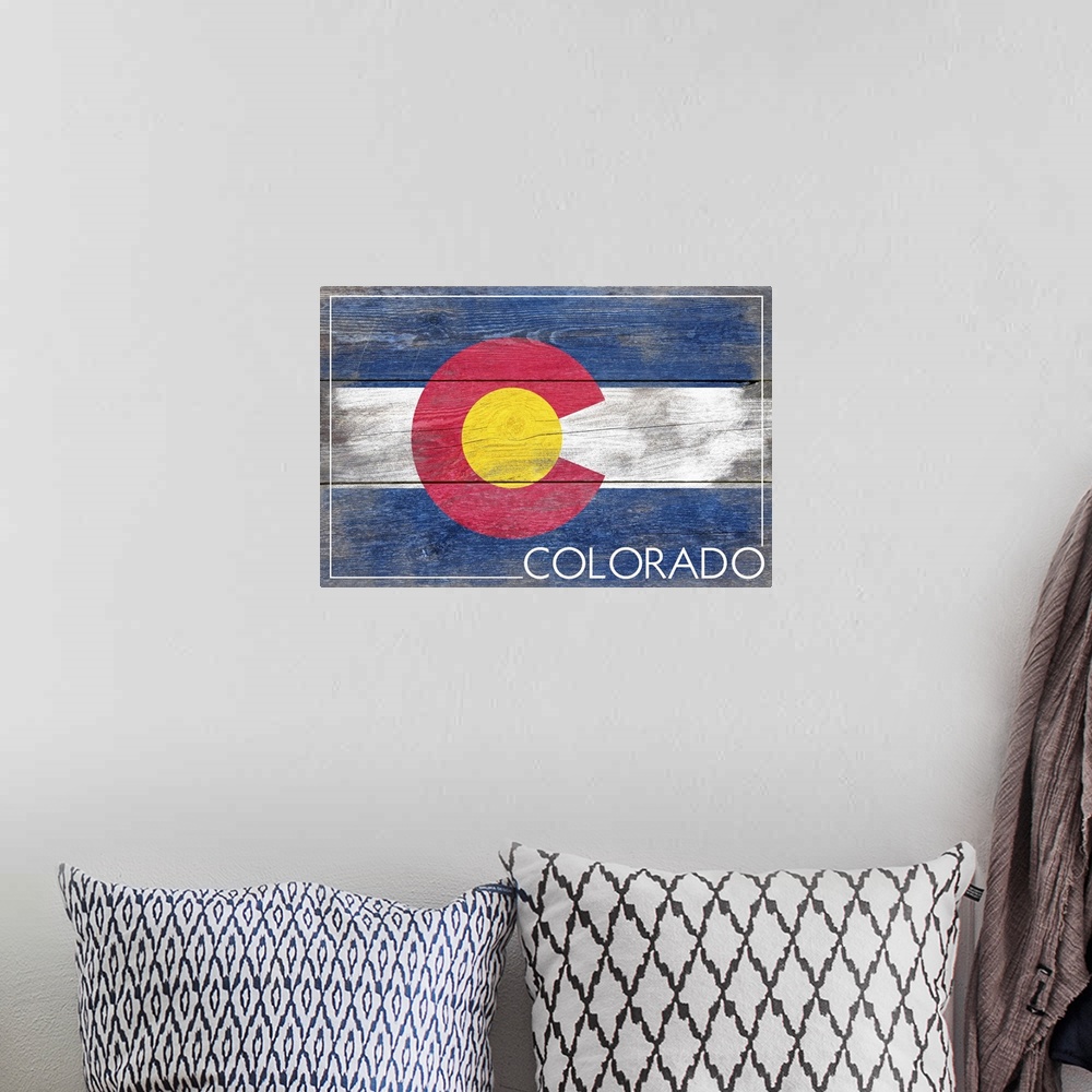 A bohemian room featuring The flag of Colorado with a weathered wooden board effect.