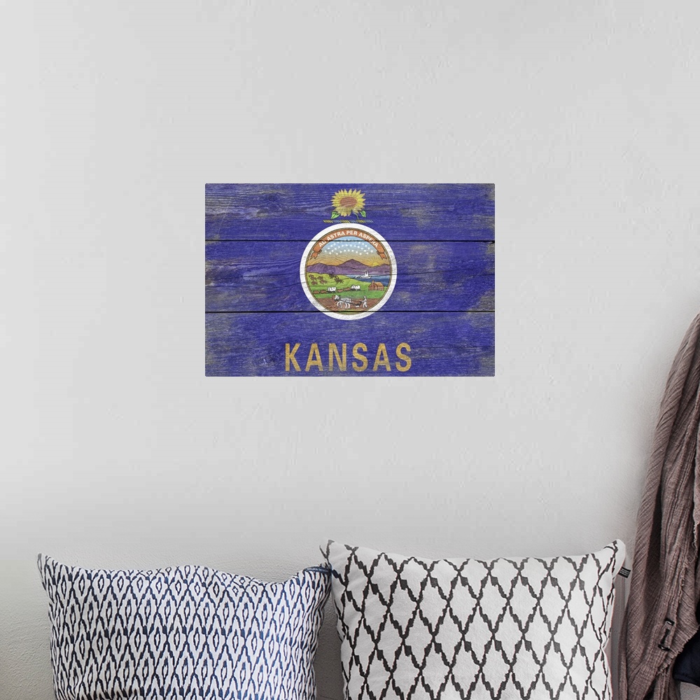 A bohemian room featuring The flag of Kansas with a weathered wooden board effect.