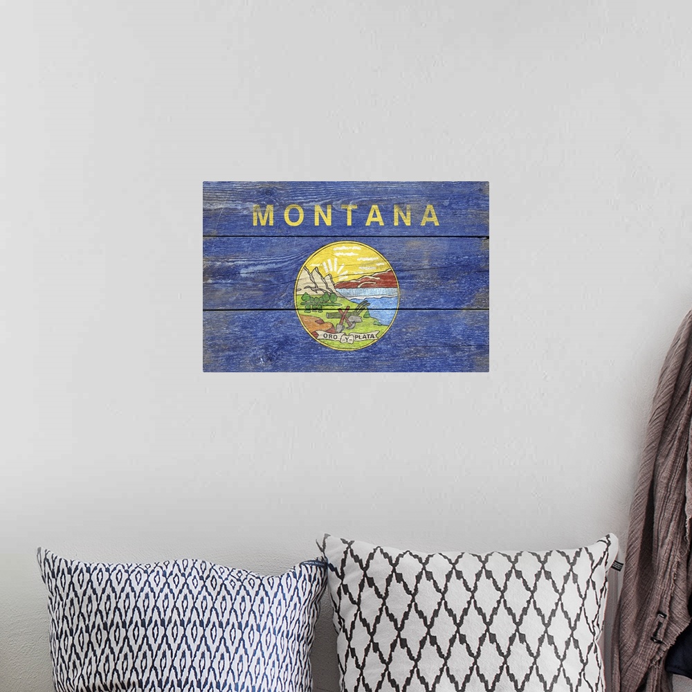 A bohemian room featuring The flag of Montana with a weathered wooden board effect.
