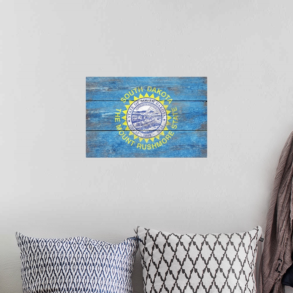 A bohemian room featuring The flag of South Dakota with a weathered wooden board effect.