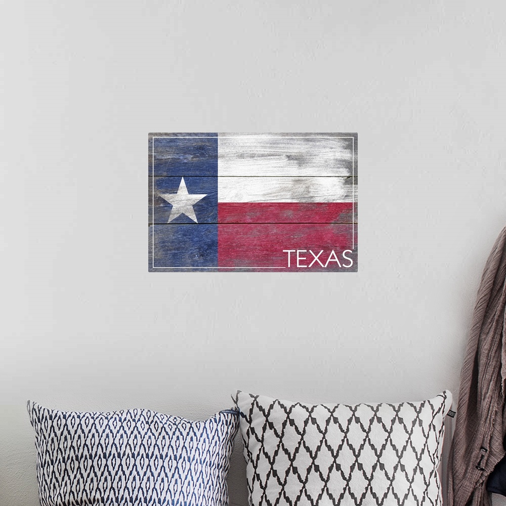 A bohemian room featuring The flag of Texas with a weathered wooden board effect.