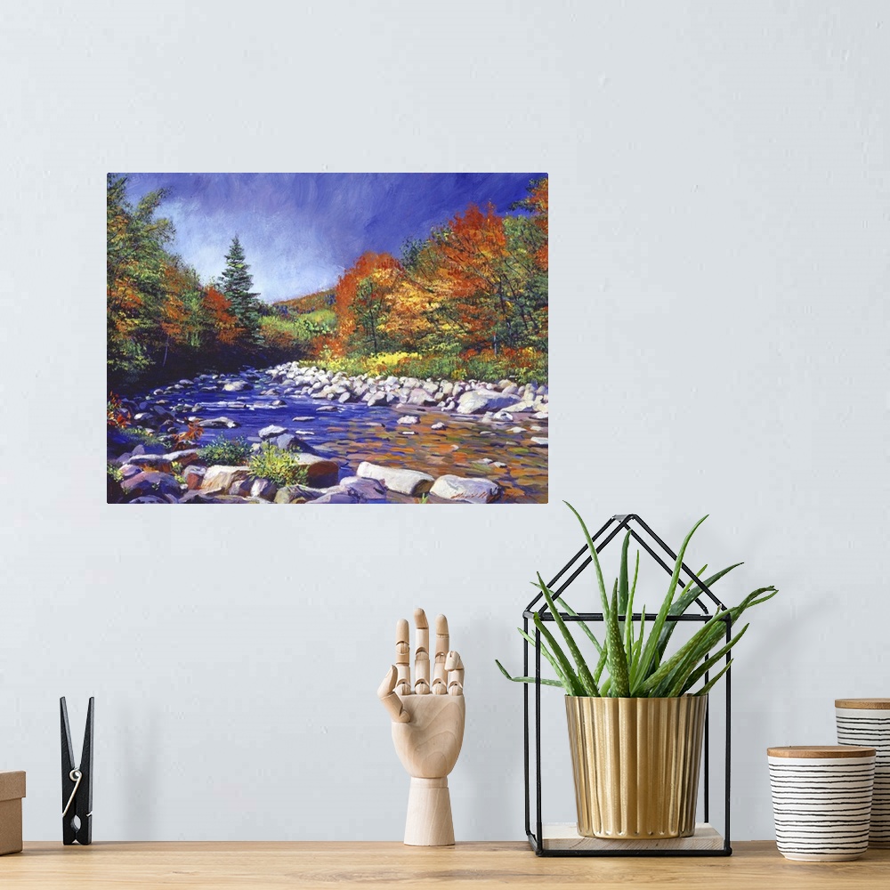 A bohemian room featuring Painting of a river lined with rocks and trees turning fall colors.