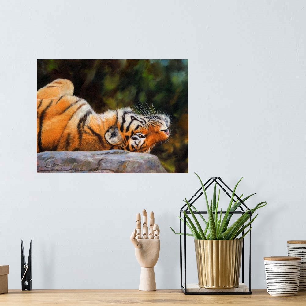 A bohemian room featuring Painting of a Siberian tiger playfully laying upside down on a rock.