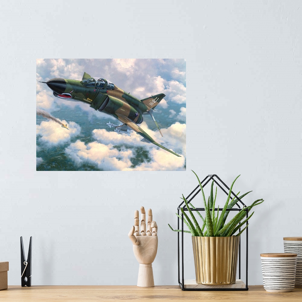 A bohemian room featuring An F-4E Phantom II flies in front of broken clouds over a tree covered jungle terrain with a Nort...