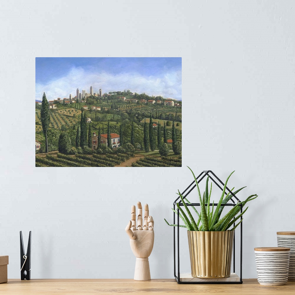 A bohemian room featuring Contemporary artwork of an European valley scattered with villages, home and vineyards.