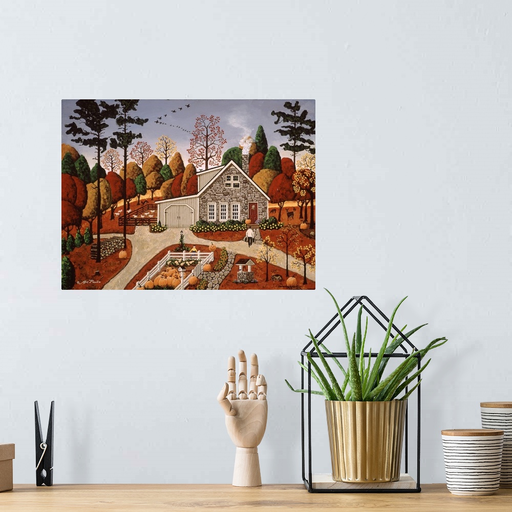 A bohemian room featuring Americana scene of a small house in autumn with several pumpkins.