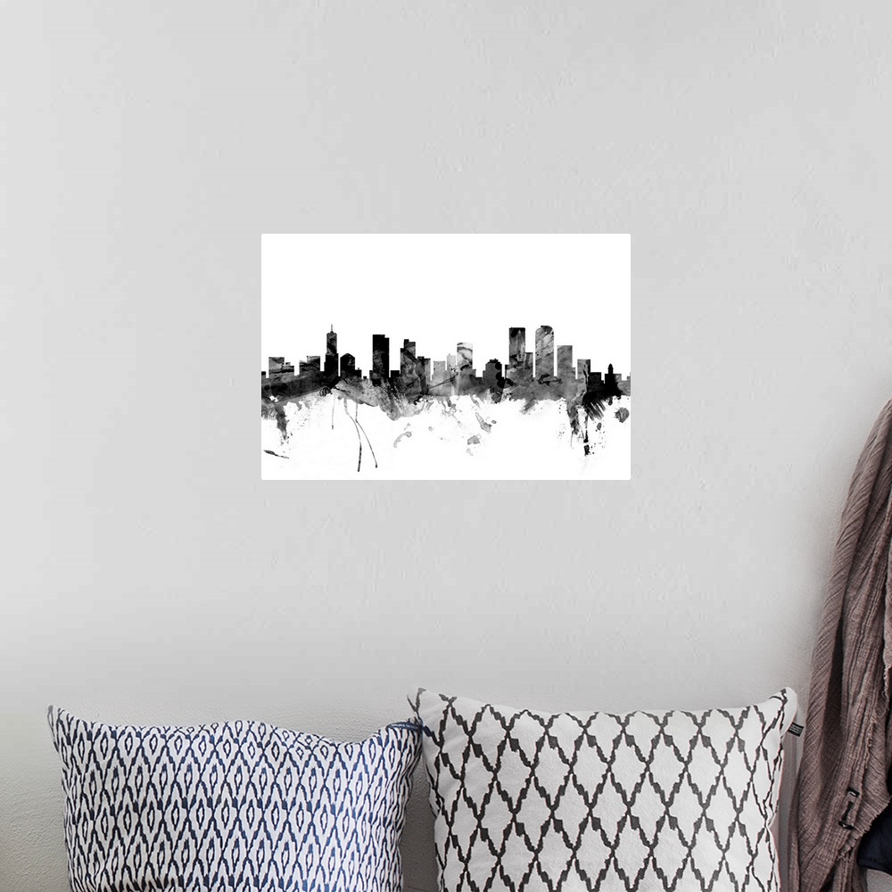 A bohemian room featuring Contemporary artwork of the Denver city skyline in black watercolor paint splashes.