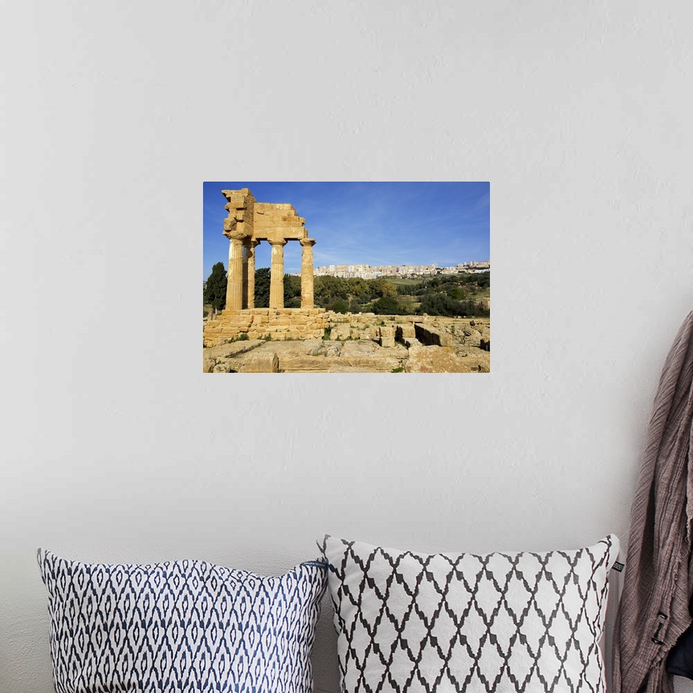 A bohemian room featuring Agrigento Greek ruins, modern city in the background, Sicily, Italy.