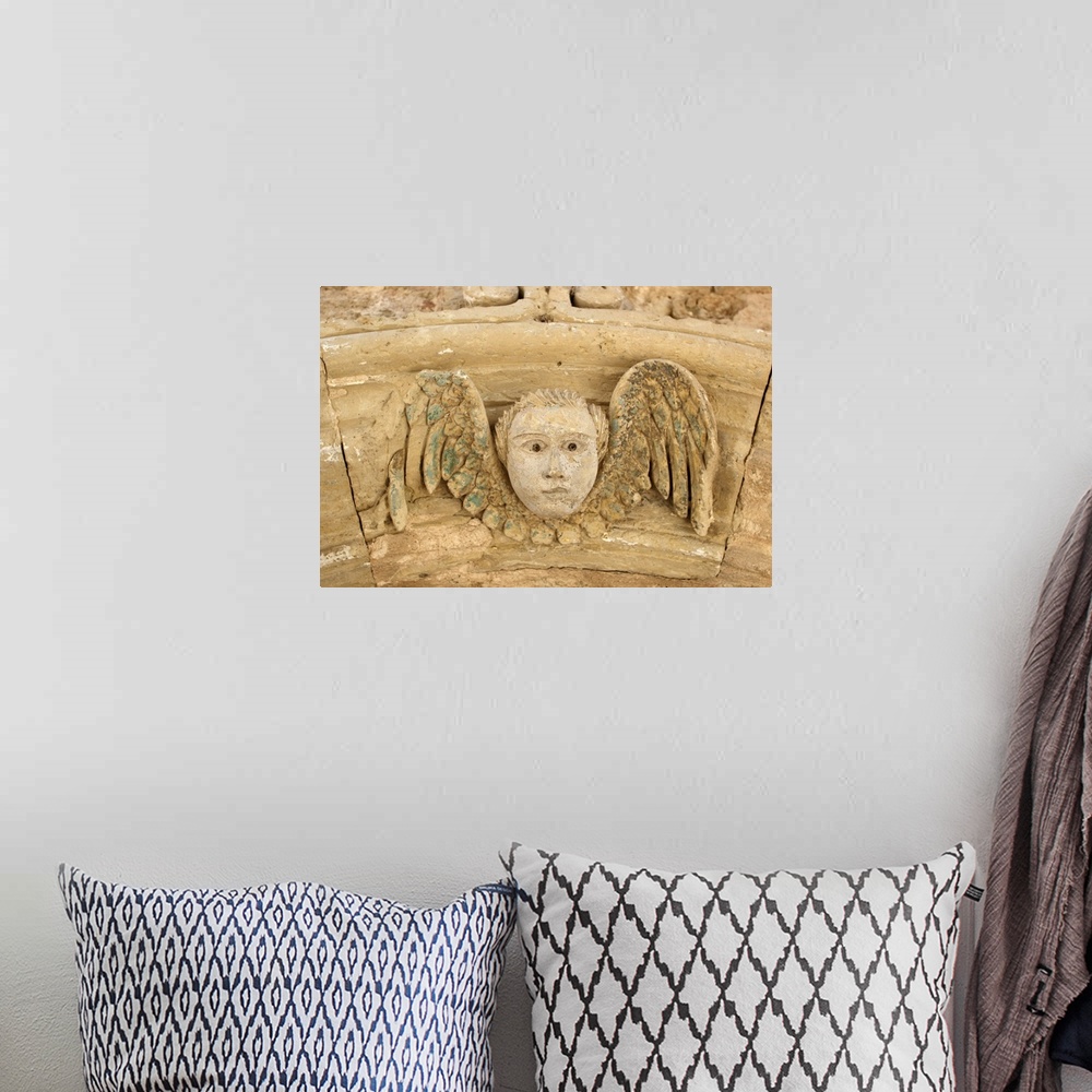 A bohemian room featuring Italy, Apulia, Otranto, angel carved in stone in a door archway