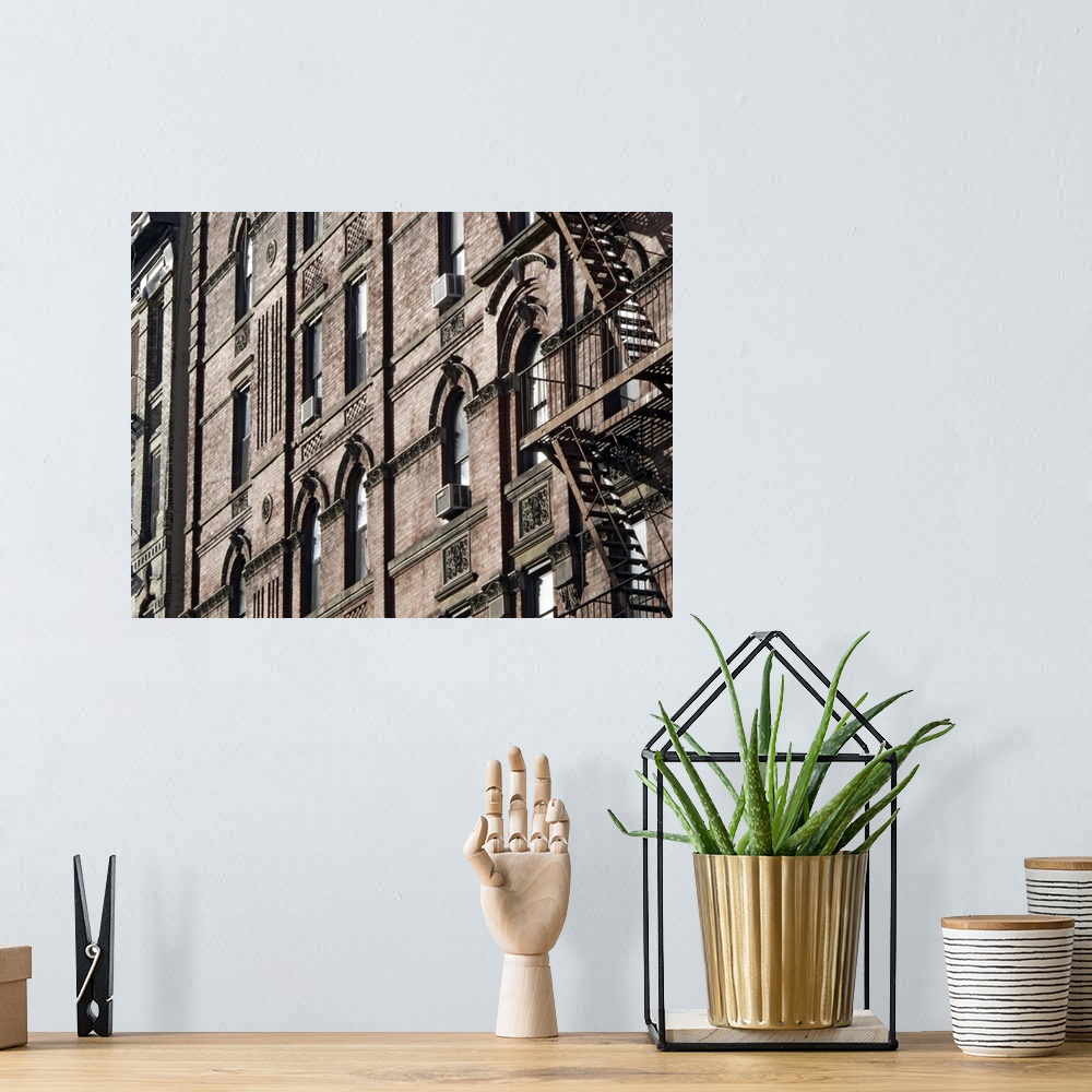 A bohemian room featuring This is a horizontal photograph of the faoade of a brick buildingos window, window mounted AC uni...