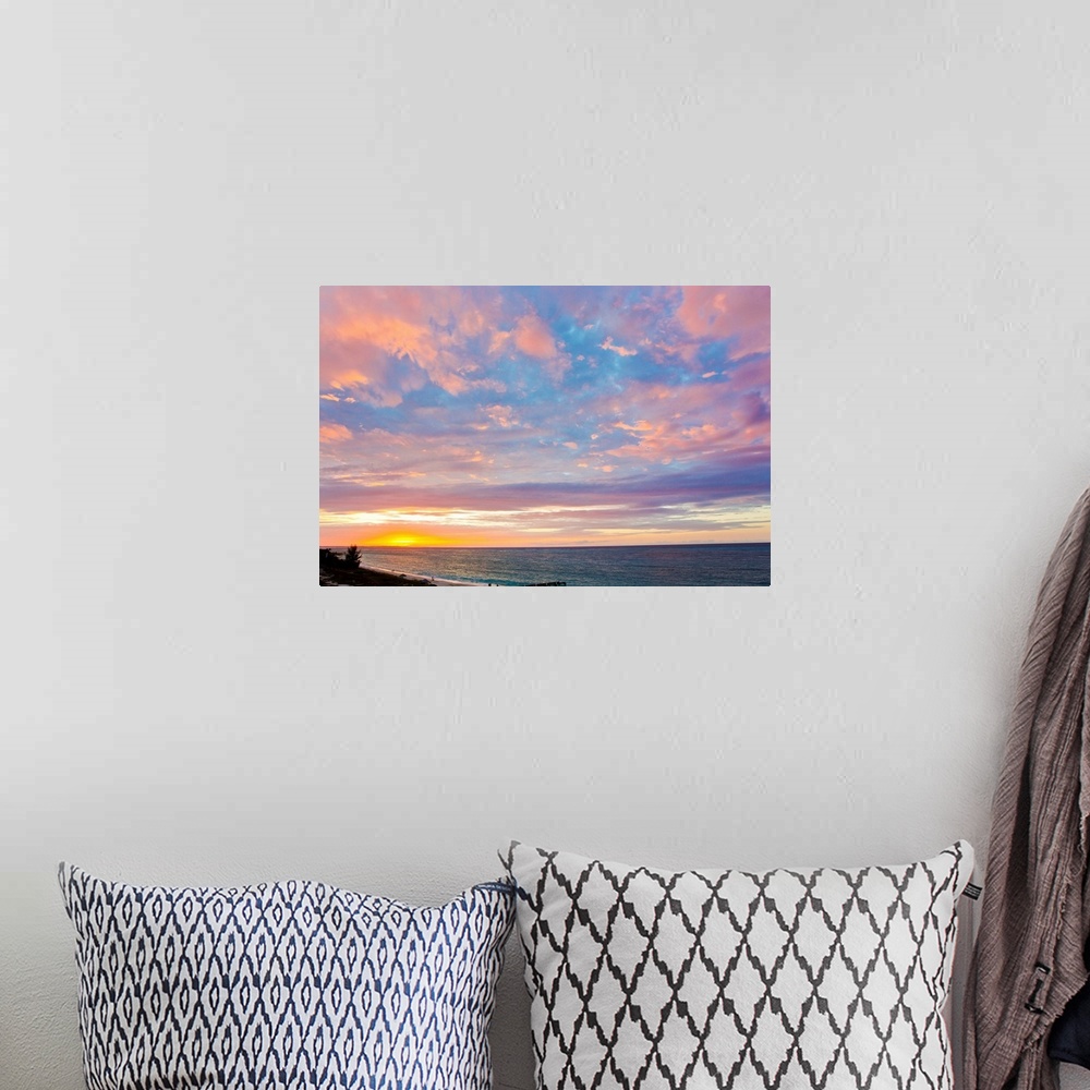 A bohemian room featuring A beautiful delicate pink and purple sky at sunset over Grace Bay, and the shore.