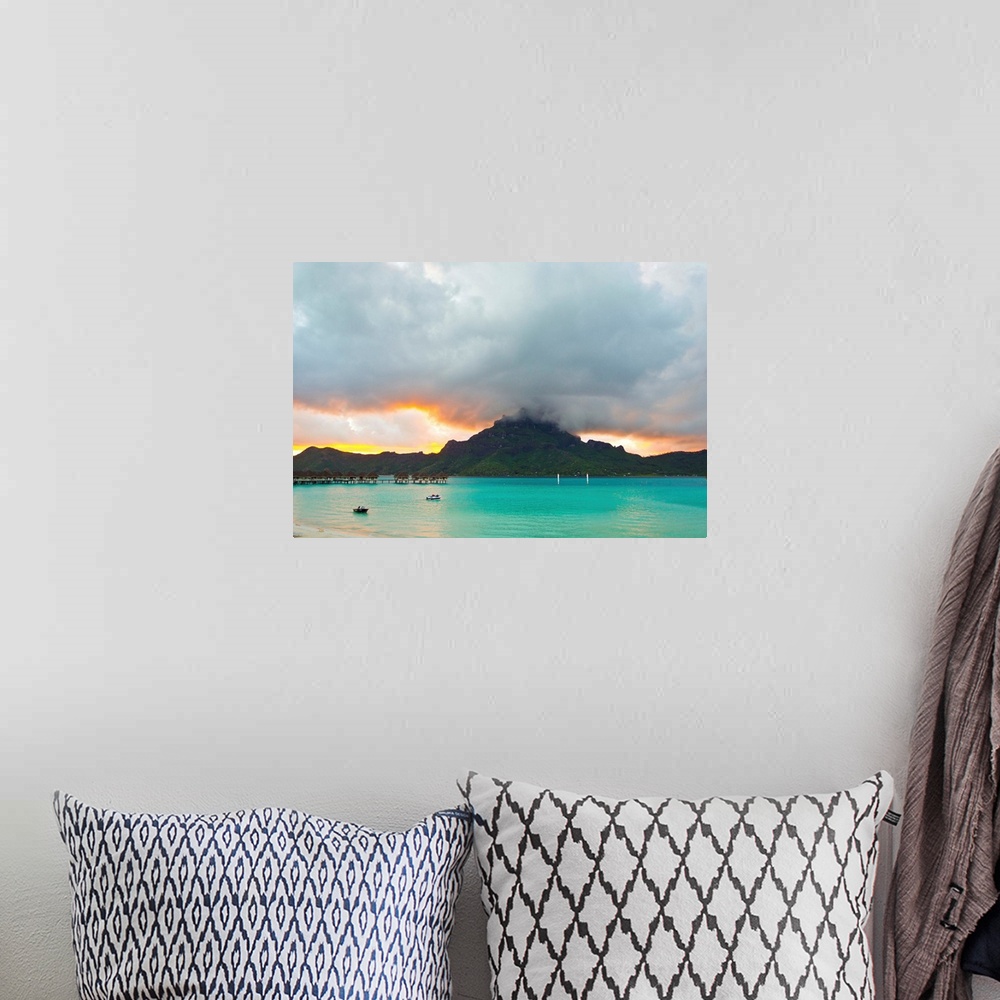 A bohemian room featuring A cloudy sunset over Mount Otemanu and the Pacific Ocean.