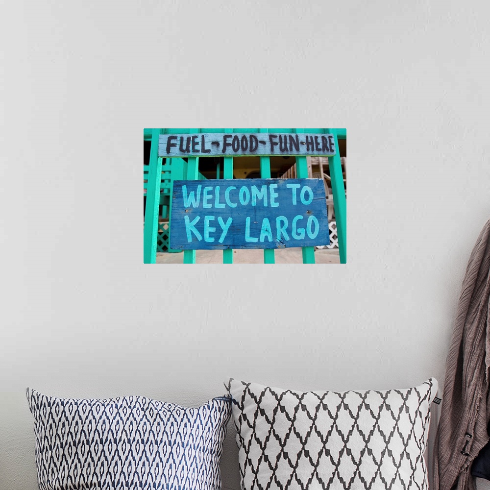 A bohemian room featuring A colorful sign welcoming people to Key Largo.