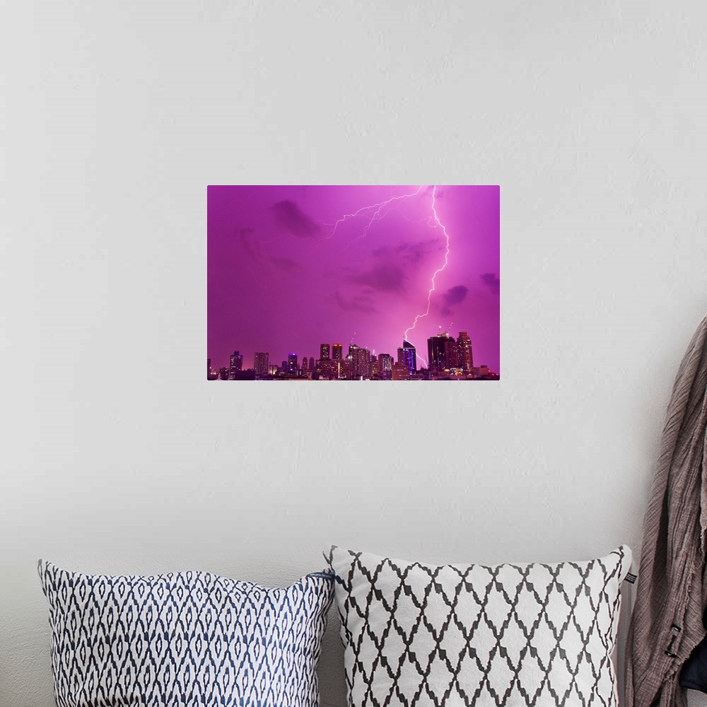 A bohemian room featuring A intense thunderstorm with lightning over the skyline of Manila.