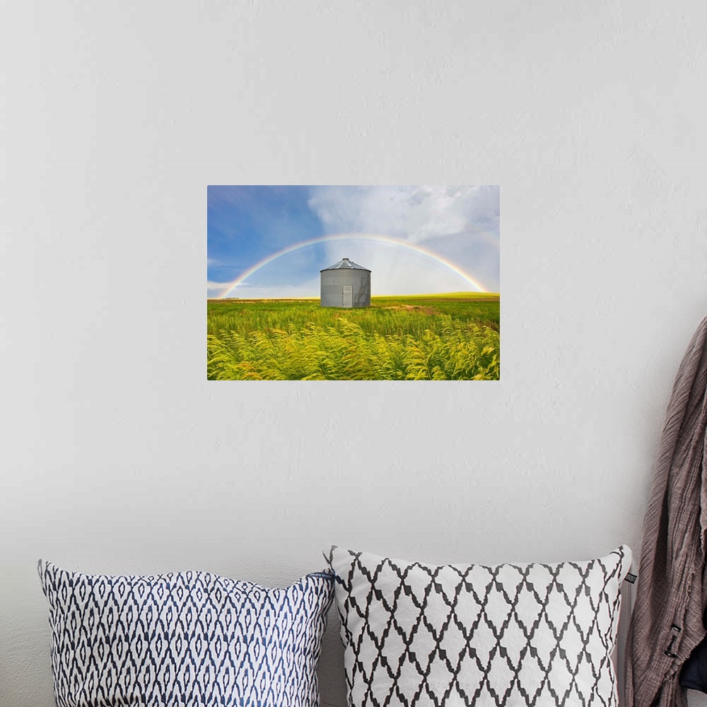 A bohemian room featuring A rainbow over a grain silo and wheat field after a thunderstorm.