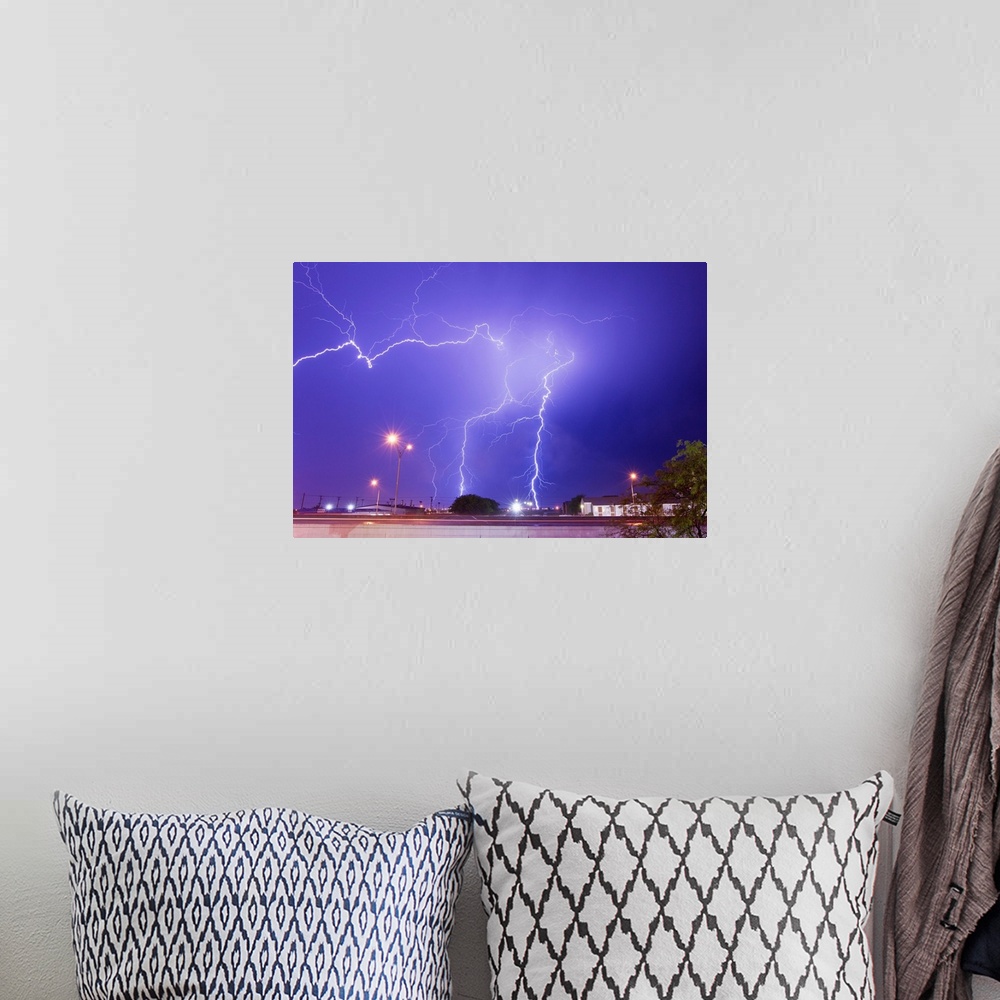 A bohemian room featuring Multiple lightning bolts stike from an intense lightning thunderstorm.