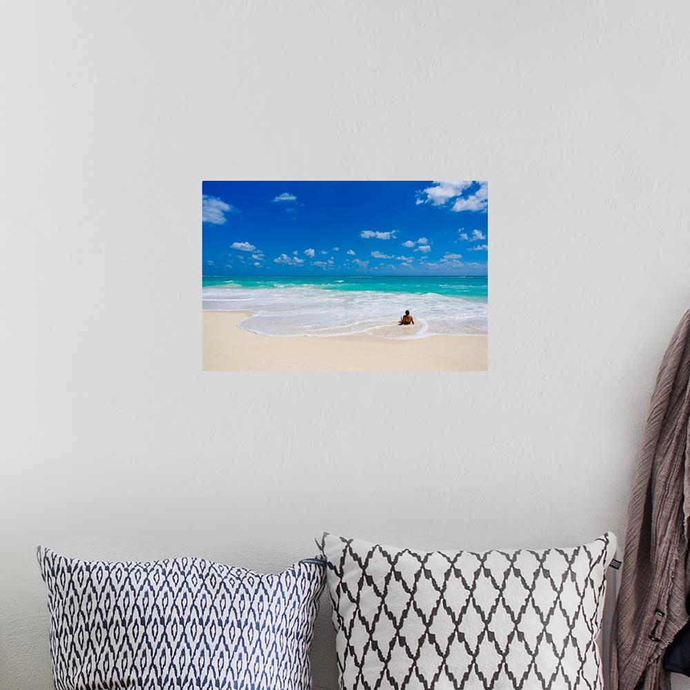 A bohemian room featuring Woman enjoys a perfect beach day of clear skies and blue waters.
