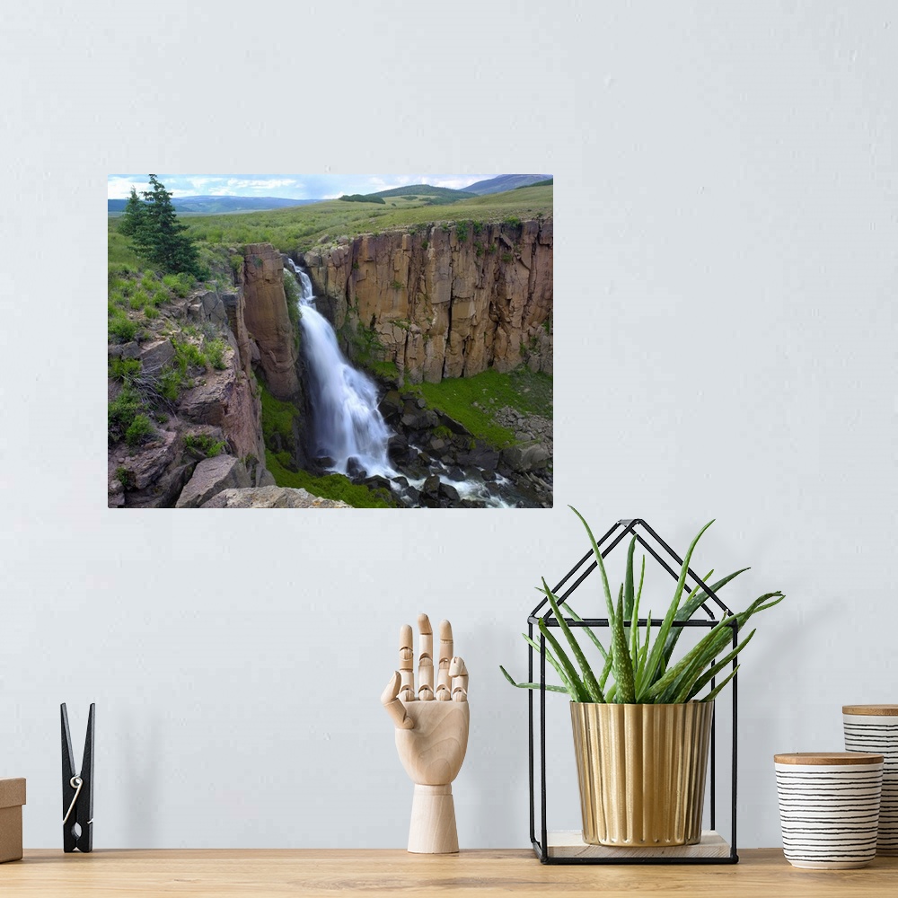 A bohemian room featuring North Clear Creek Waterfall cascading down cliff, Colorado