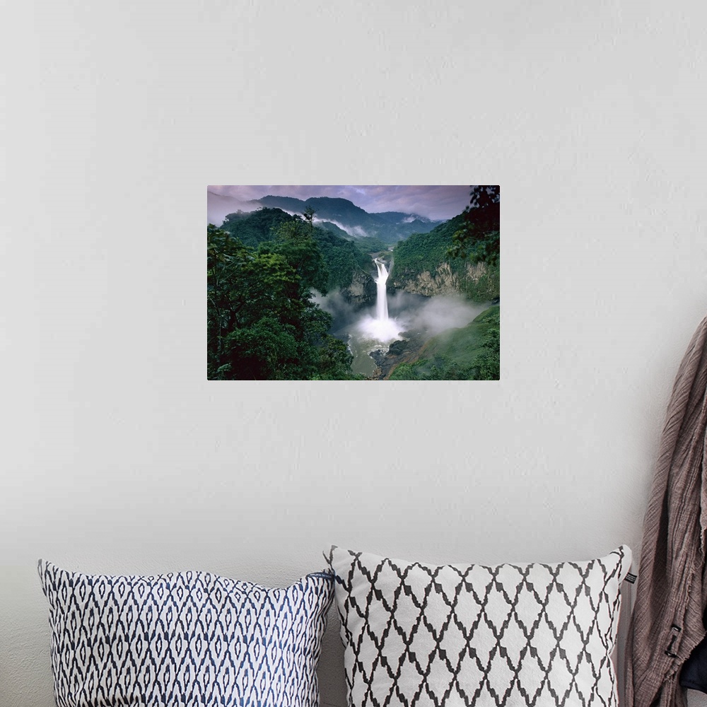 A bohemian room featuring Photograph of waterfall surrounded by rainforest with mountain silhouette in the distance.