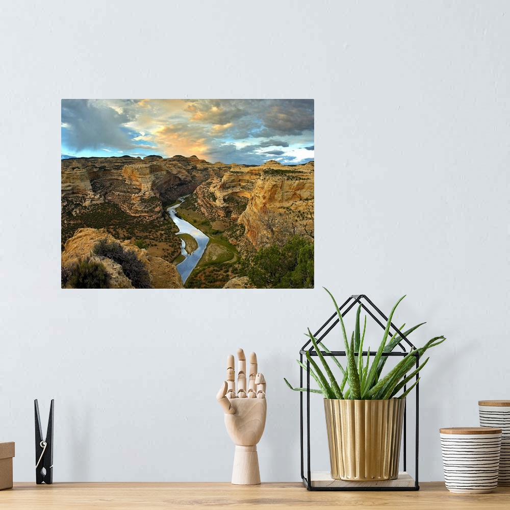 A bohemian room featuring High angle photograph of river flowing through canyon under a cloudy sky.