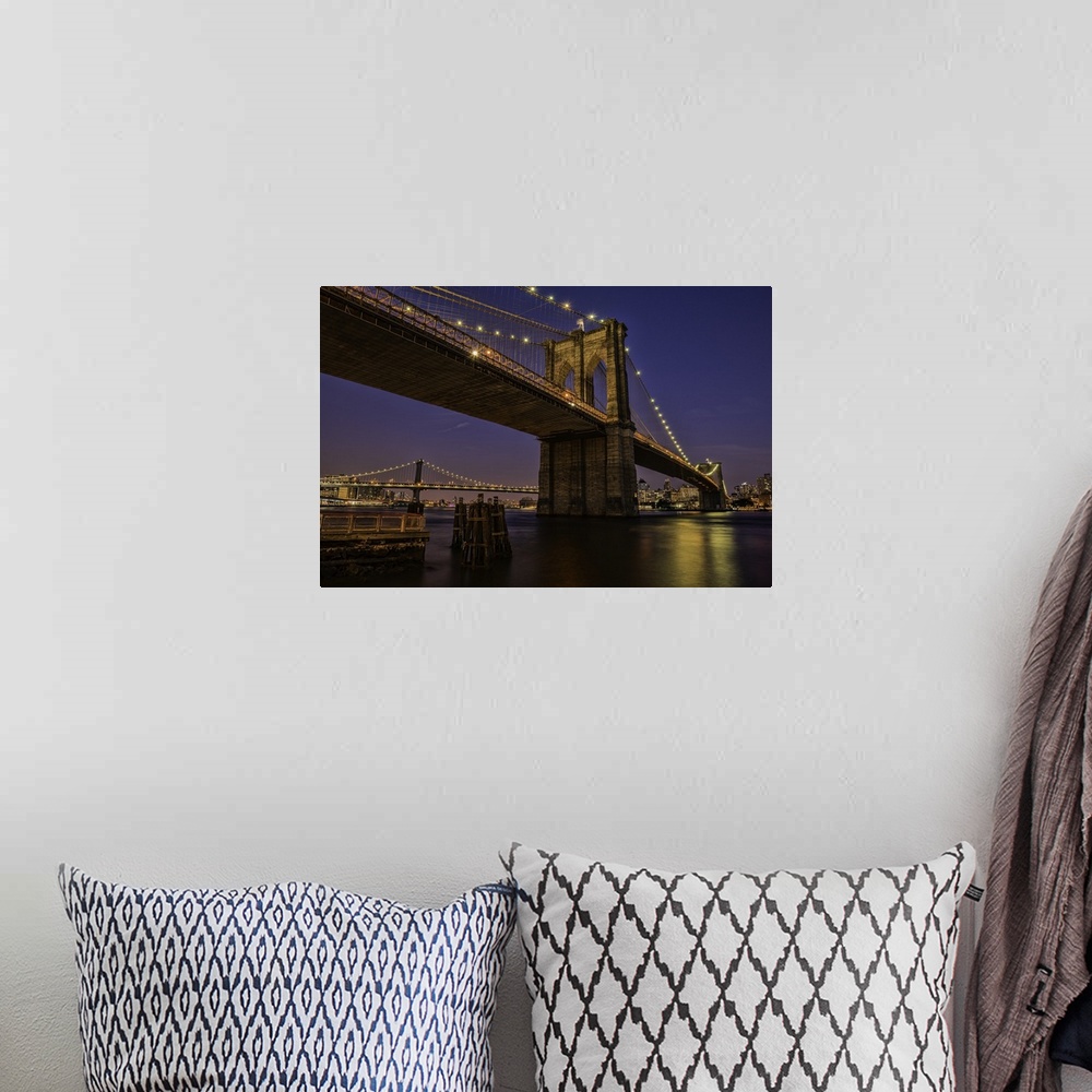 A bohemian room featuring A photograph of the Brooklyn bridge at twilight.