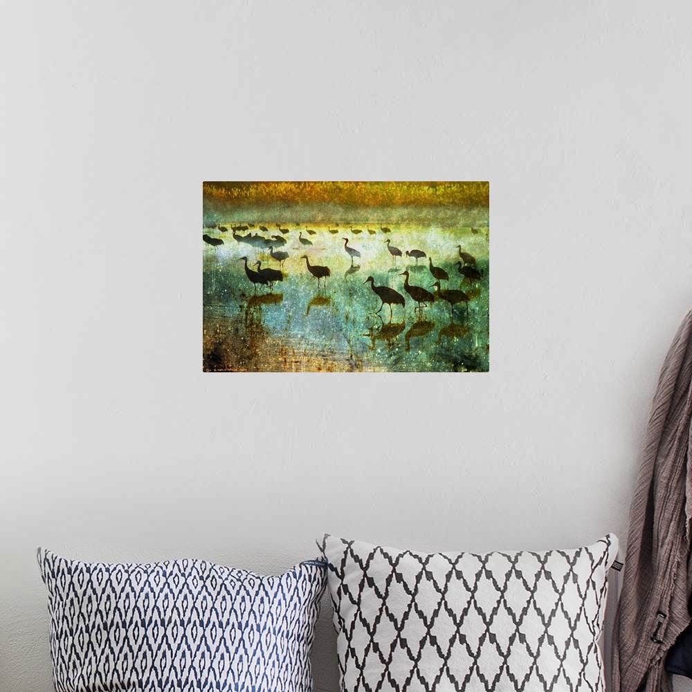 A bohemian room featuring Contemporary artwork of silhouetted cranes standing in water.