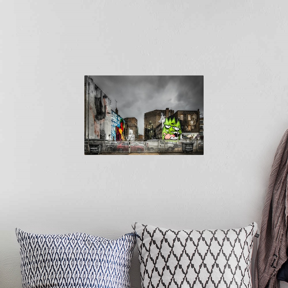 A bohemian room featuring Fine art photograph of a graffiti on the facade of a city building.