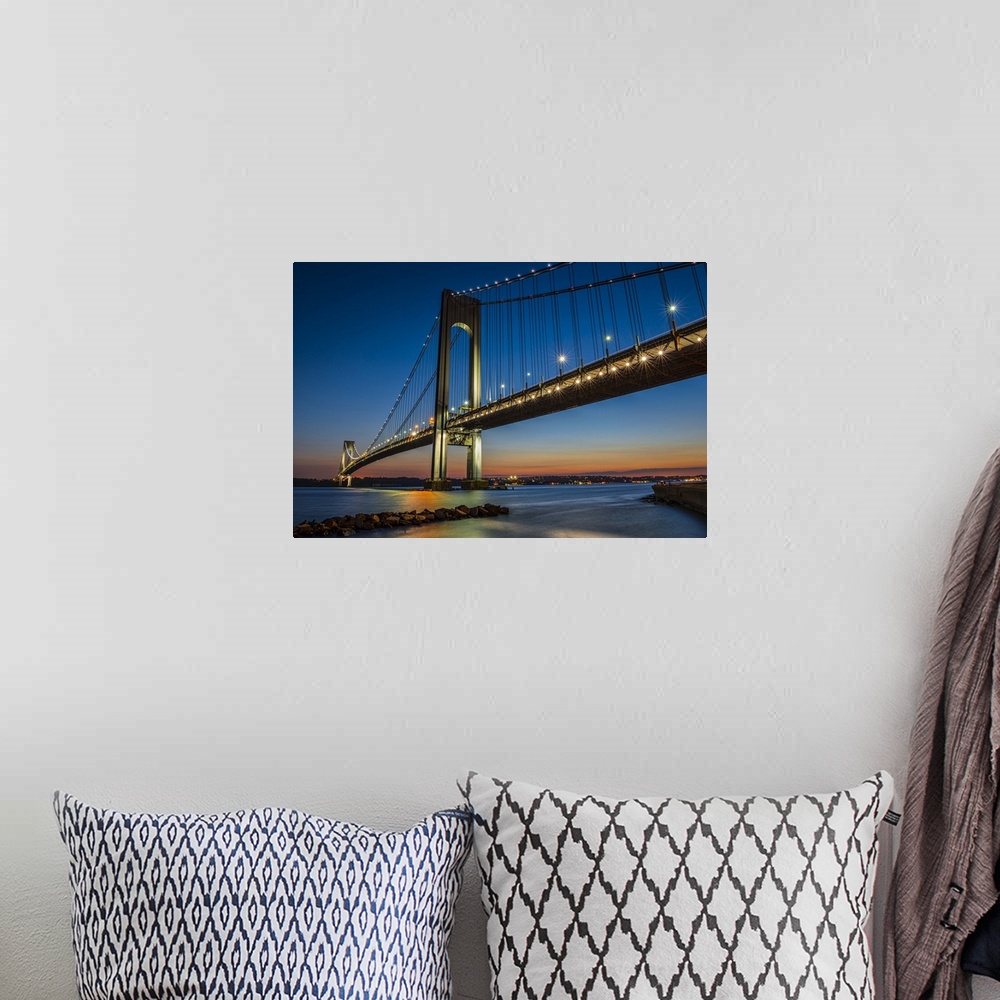A bohemian room featuring A photograph of the Verrazano-Narrows Bridge at twilight.