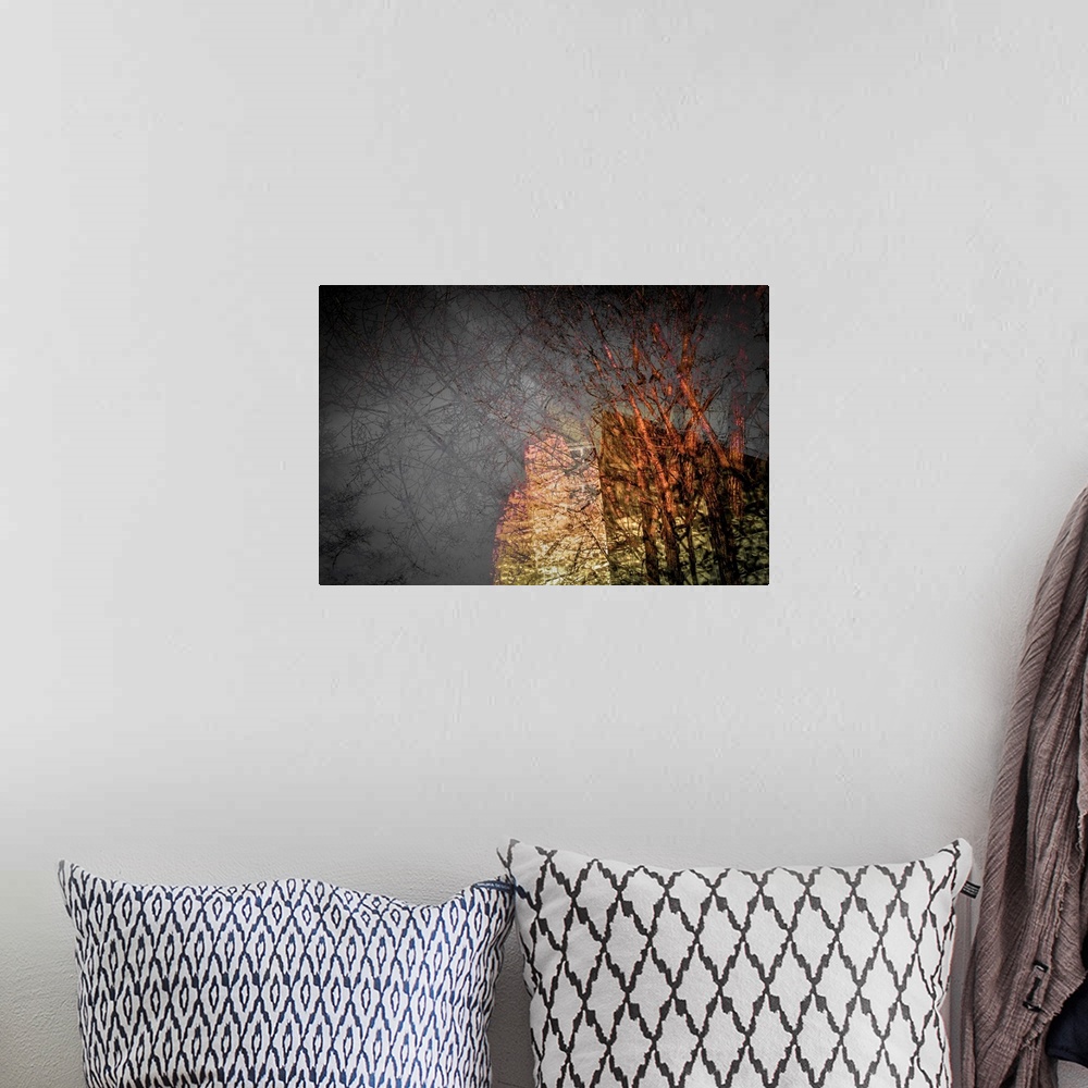A bohemian room featuring Abstract composite of trees and a building with rough textures in brown, red, and white.