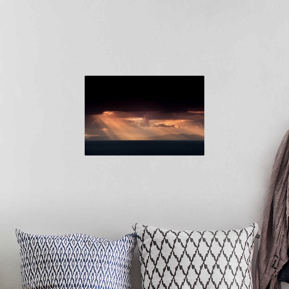 A bohemian room featuring Fine art photo of beams of light coming from dark clouds over a lake.