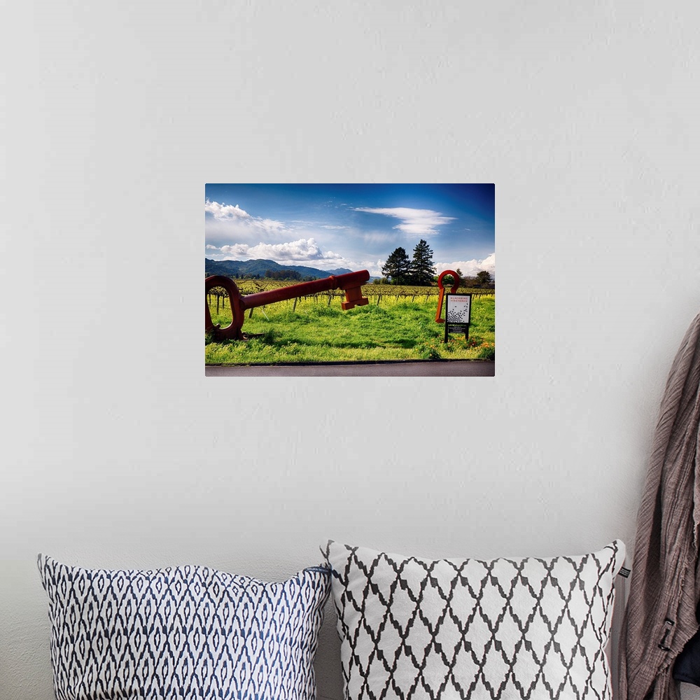 A bohemian room featuring Fine art photo of a large key sculpture near the entrance to a vineyard.