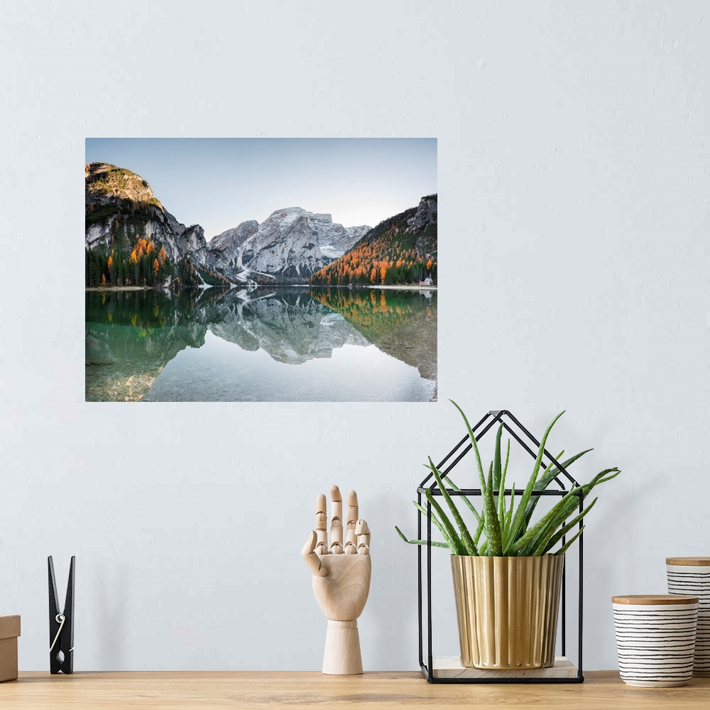 A bohemian room featuring Fine art photograph of the snowy mountains in Italy reflected in Braies lake.