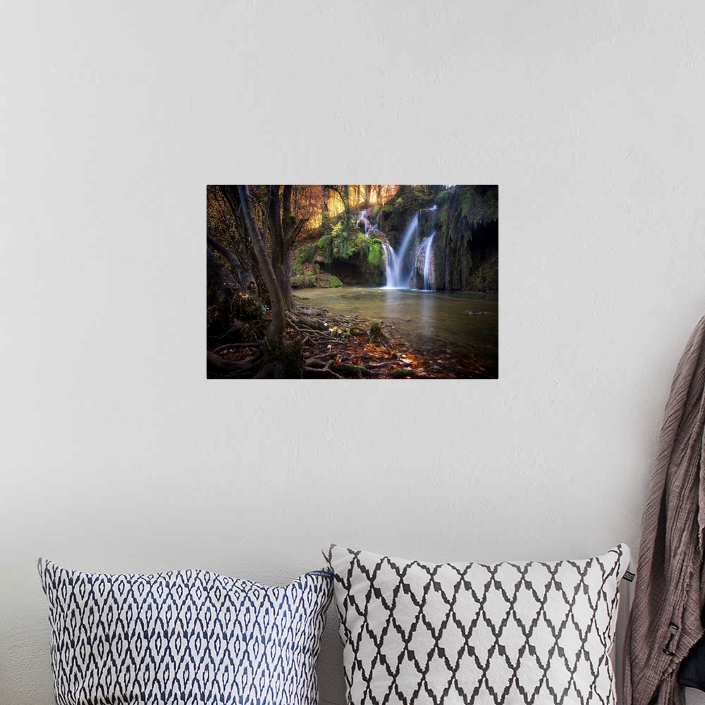 A bohemian room featuring Fine art photograph of a waterfall in a forest in France.