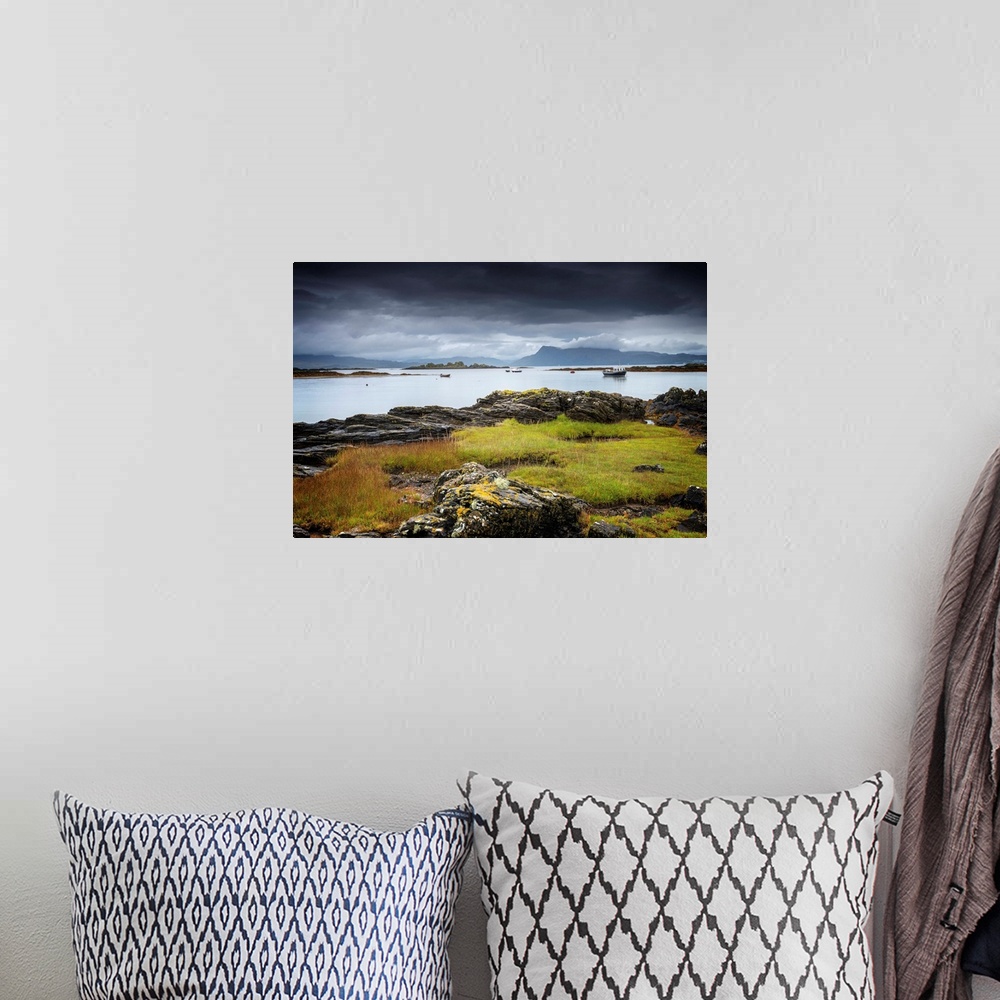 A bohemian room featuring Fine art photo of a rocky coast under a dark stormy sky.
