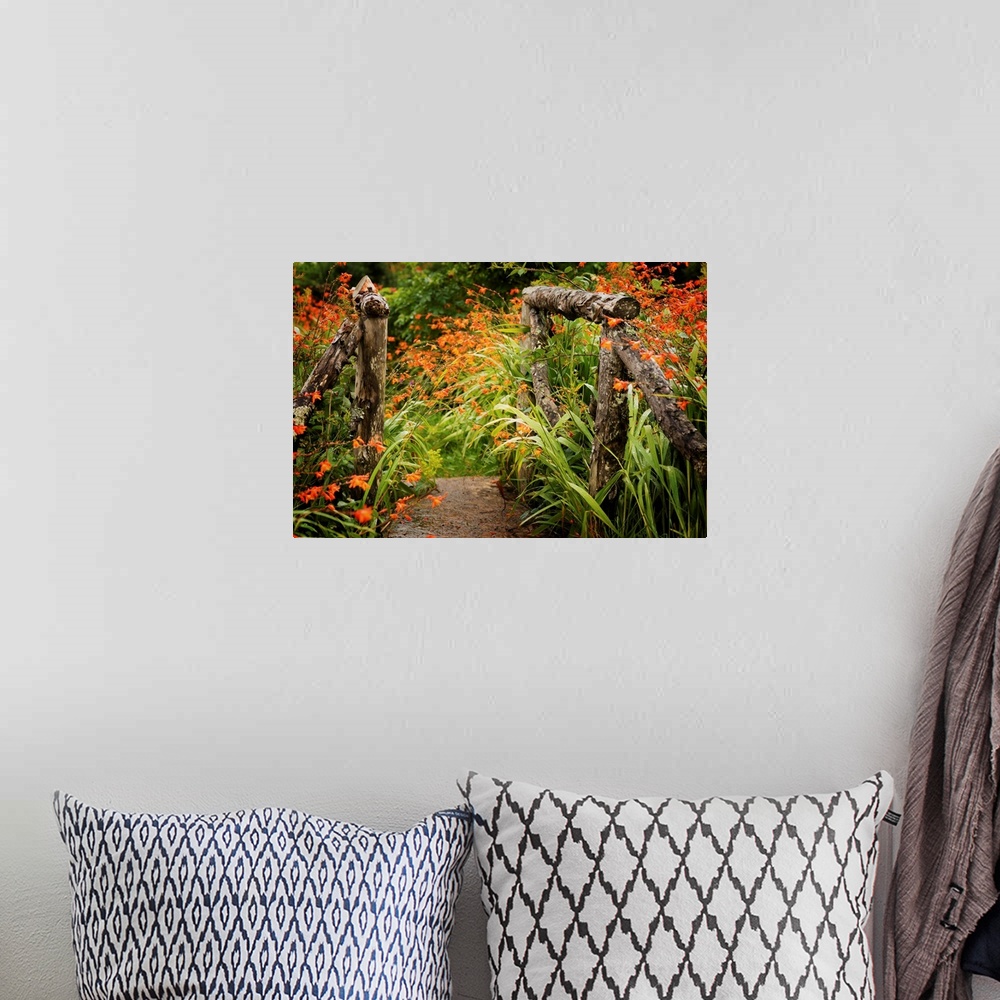 A bohemian room featuring Fine art photo of a garden path with bright flowers and a wooden gate.