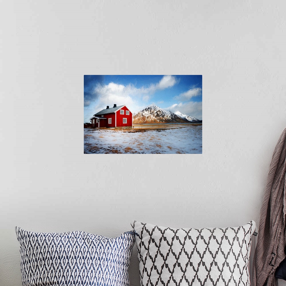 A bohemian room featuring A photograph of a mountain landscape with a red house in the foreground of the image.