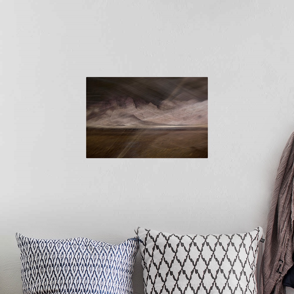 A bohemian room featuring Abstract image of a desert storm with thin lines on top creating movement and a rocky textured ba...