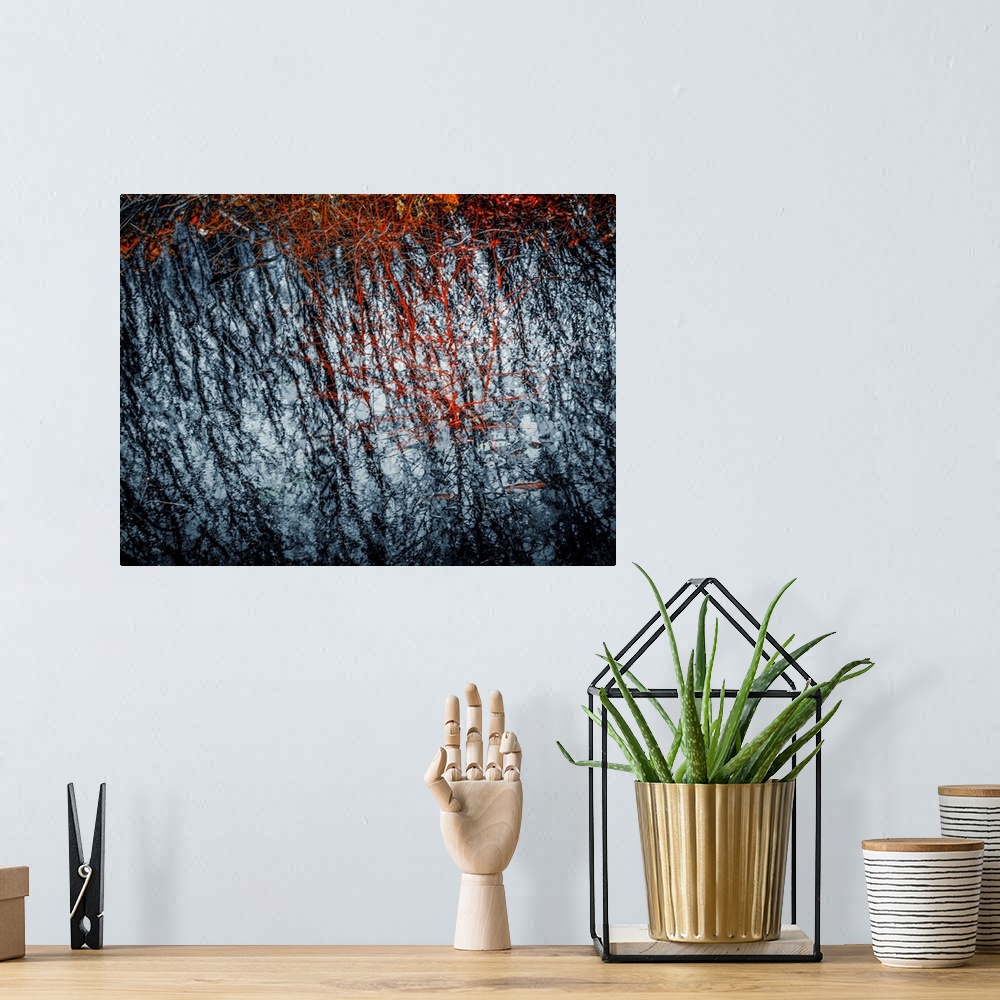 A bohemian room featuring Abstract photograph with rough textures in black, red, and white.