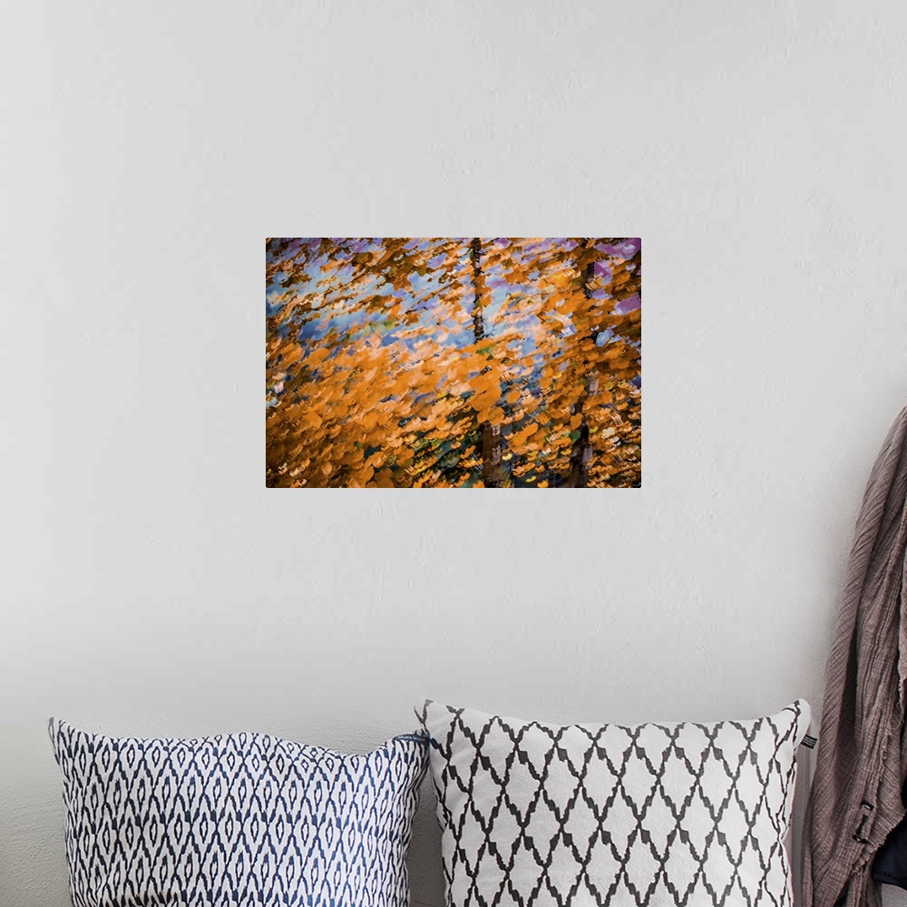 A bohemian room featuring Fall leaves against a warm sky.