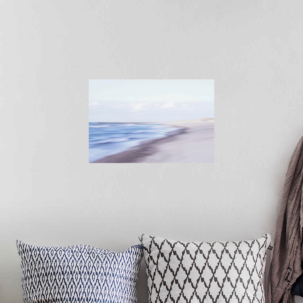 A bohemian room featuring Artistically blurred photo. The waves find a place to rest on the North Sea beach of North Jutlan...
