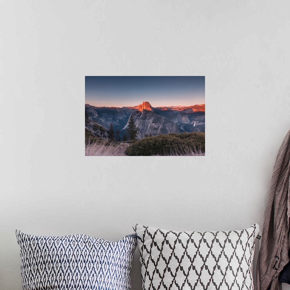 A bohemian room featuring Half Dome in golden color during sunset at Glacier Point, Yosemite National Park, California.