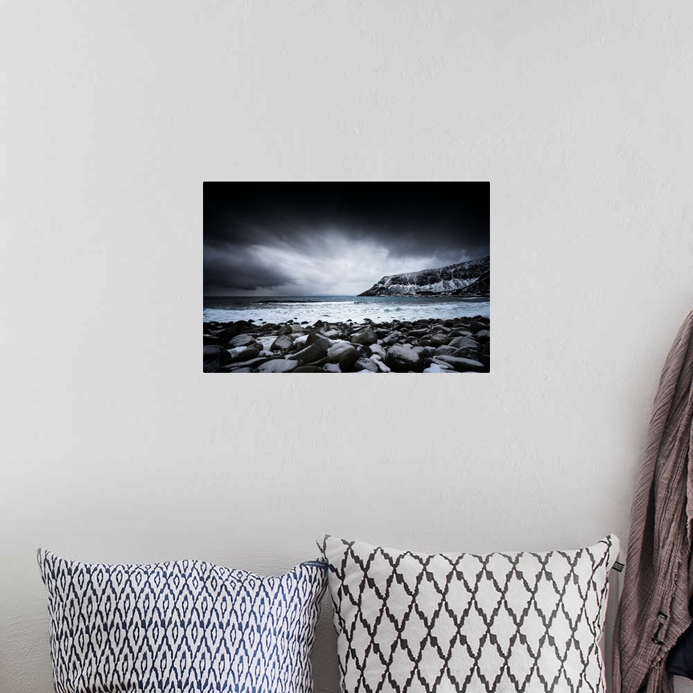 A bohemian room featuring A photograph of a rugged winter landscape under a sky of dark clouds.