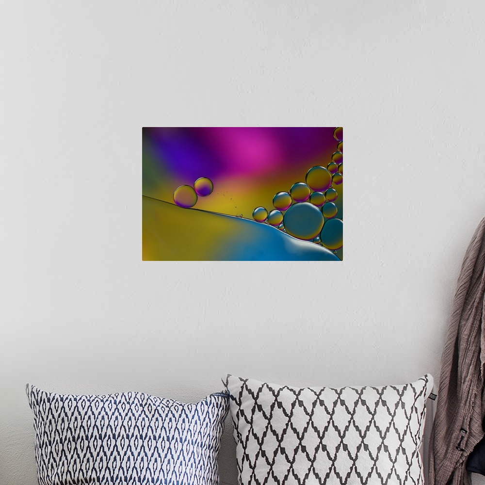 A bohemian room featuring Abstract photograph of transparent droplets stacked together with blue, yellow, pink, and purple ...