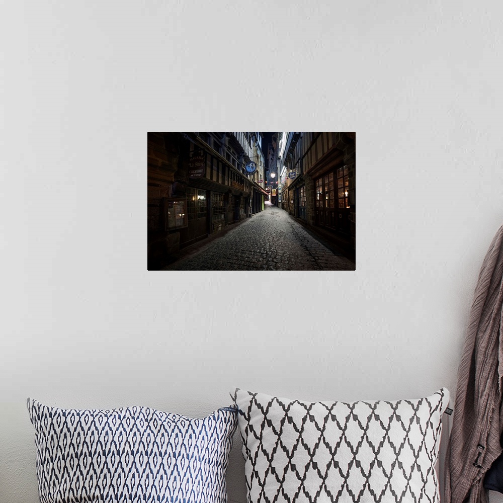 A bohemian room featuring Fine art photo of a dark alleyway with cobblestone  in France.