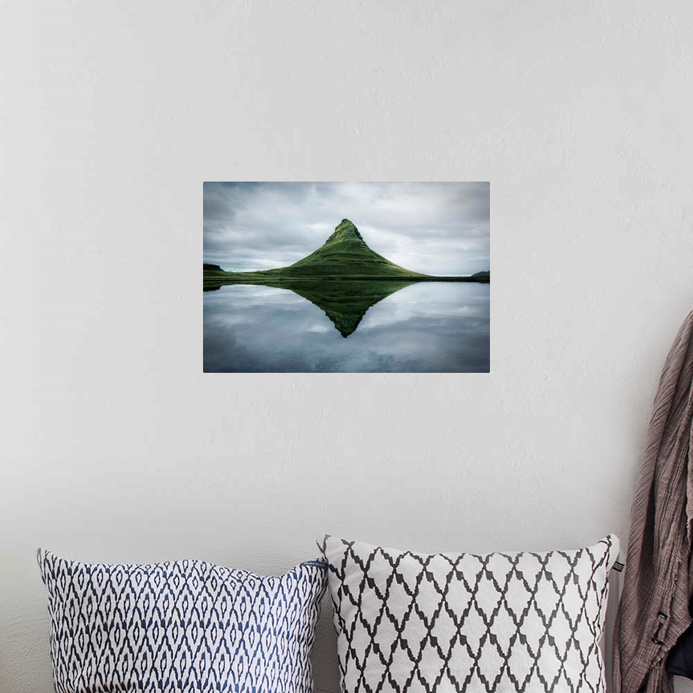 A bohemian room featuring Fine art photograph of the tall peak of Kirkjufell overlooking a calm lake in Iceland.