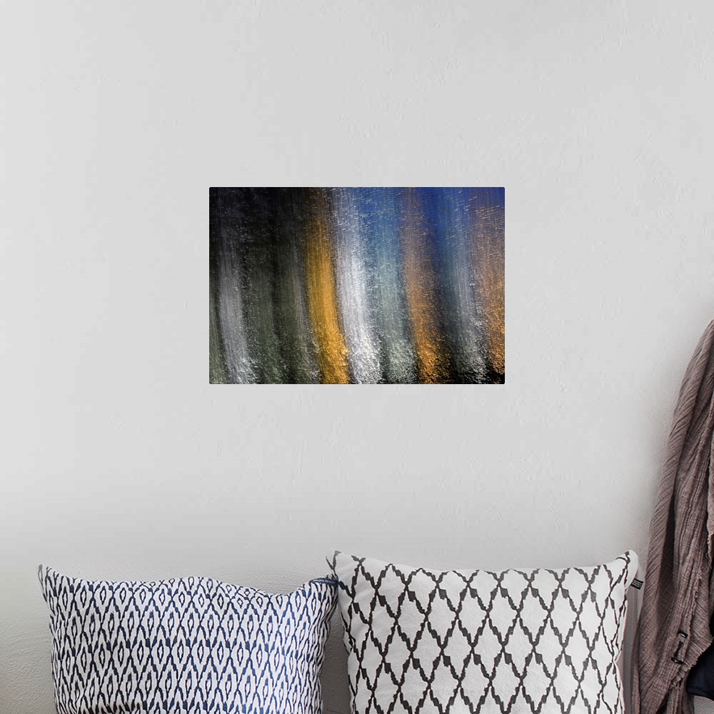 A bohemian room featuring Fine art photograph of silver, gold, and white reflections of light on water in vertical lines.