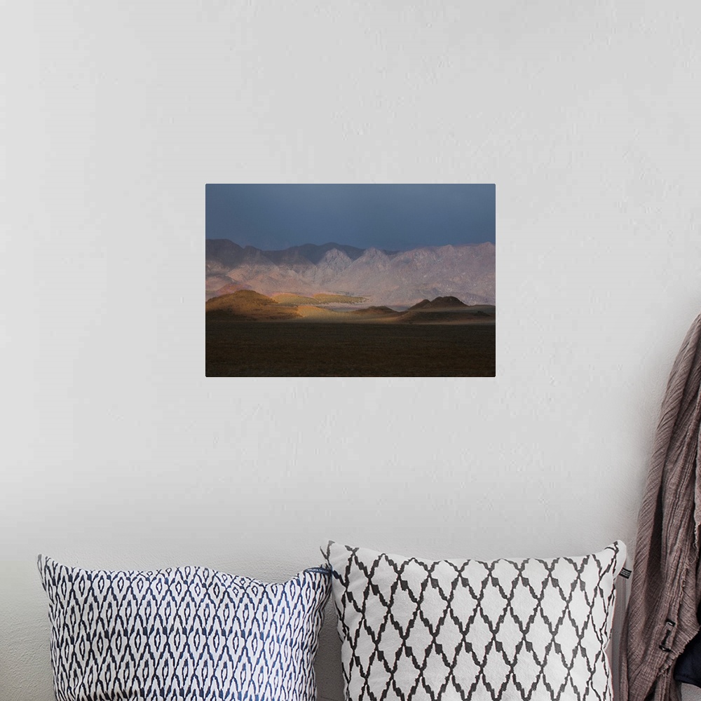 A bohemian room featuring Composited landscape image with rolling hills and mountains.
