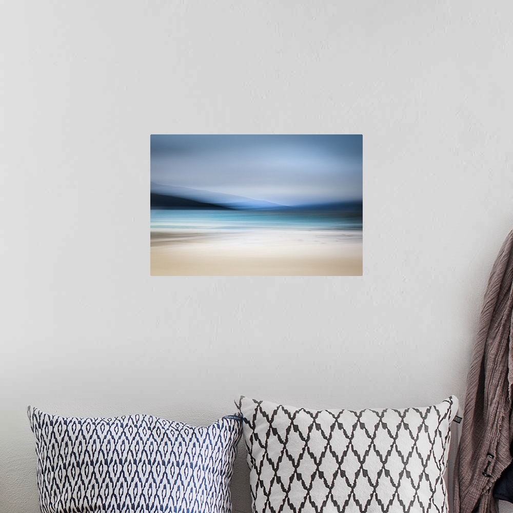 A bohemian room featuring Calming abstract landscape beach scene with mountains, teal water, and grey sky.