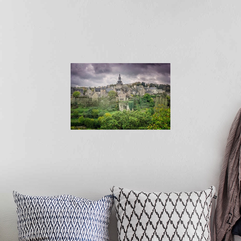 A bohemian room featuring A photograph of a historic village in France.