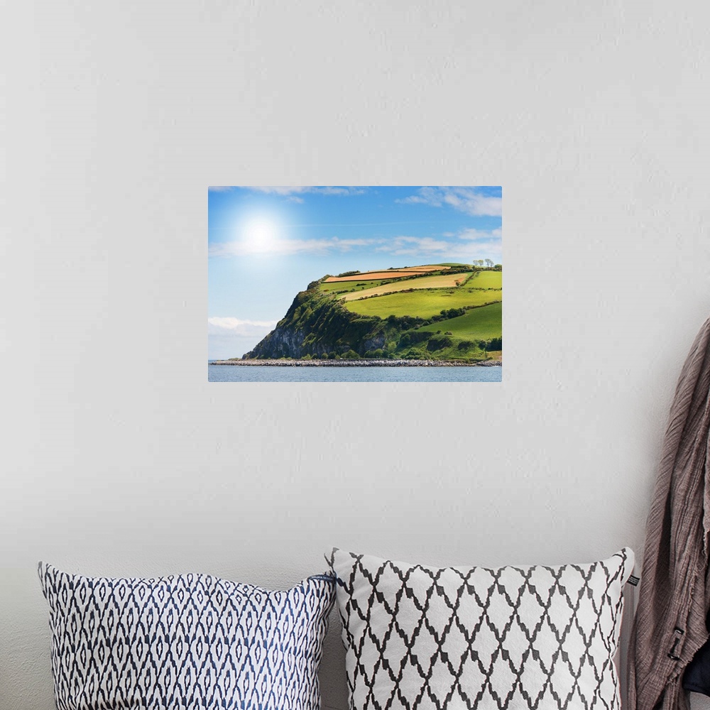 A bohemian room featuring A photograph of a coastal landscape.